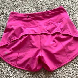 Like new 2023 Lululemon pink running shorts with back zipper pocket (lined).